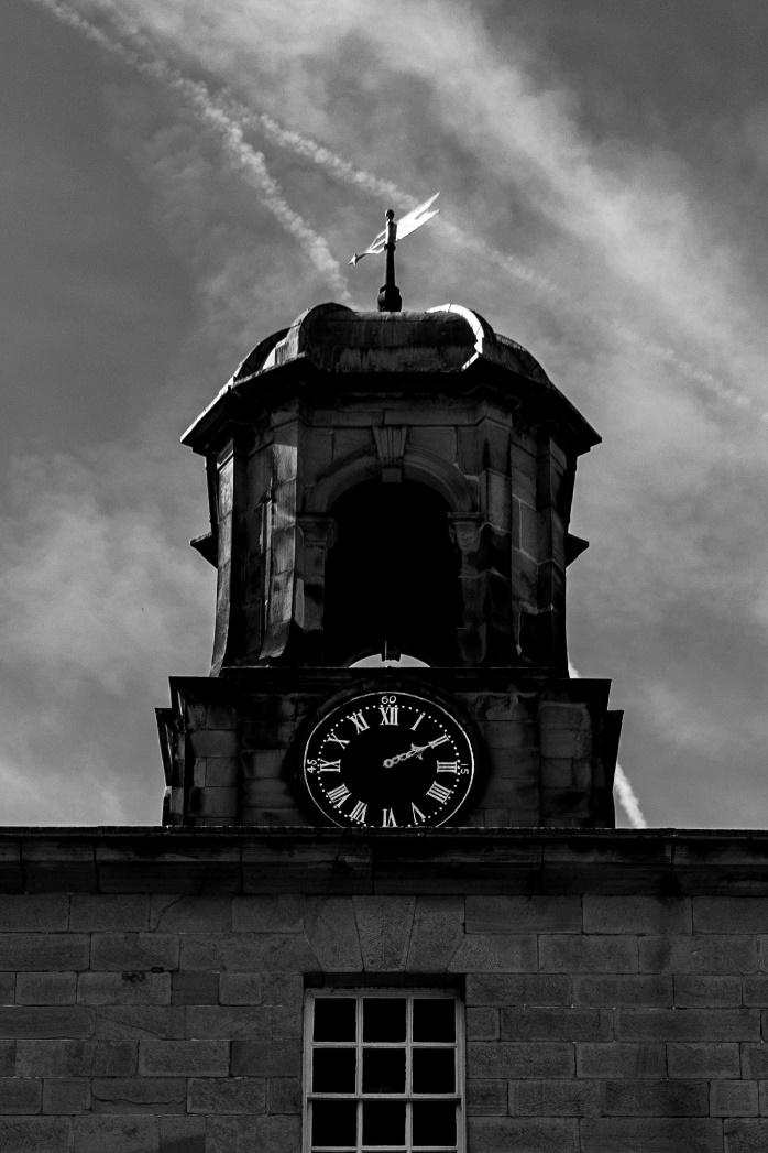 Stylish black and white photo of a clock tower at Chatsworth House